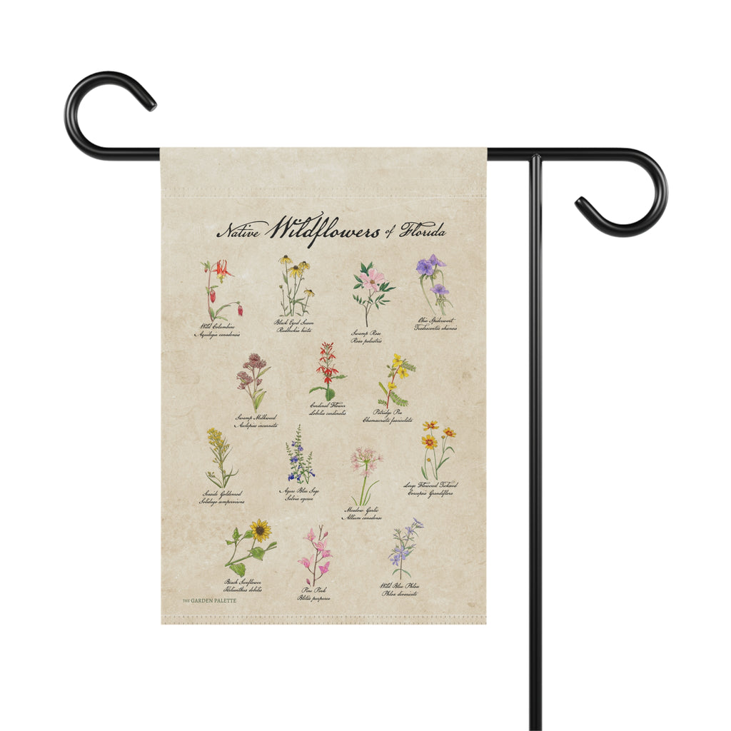 Decorative garden flag with illustrations of wildflowers on a beige background, attached to a black metal flagpole.