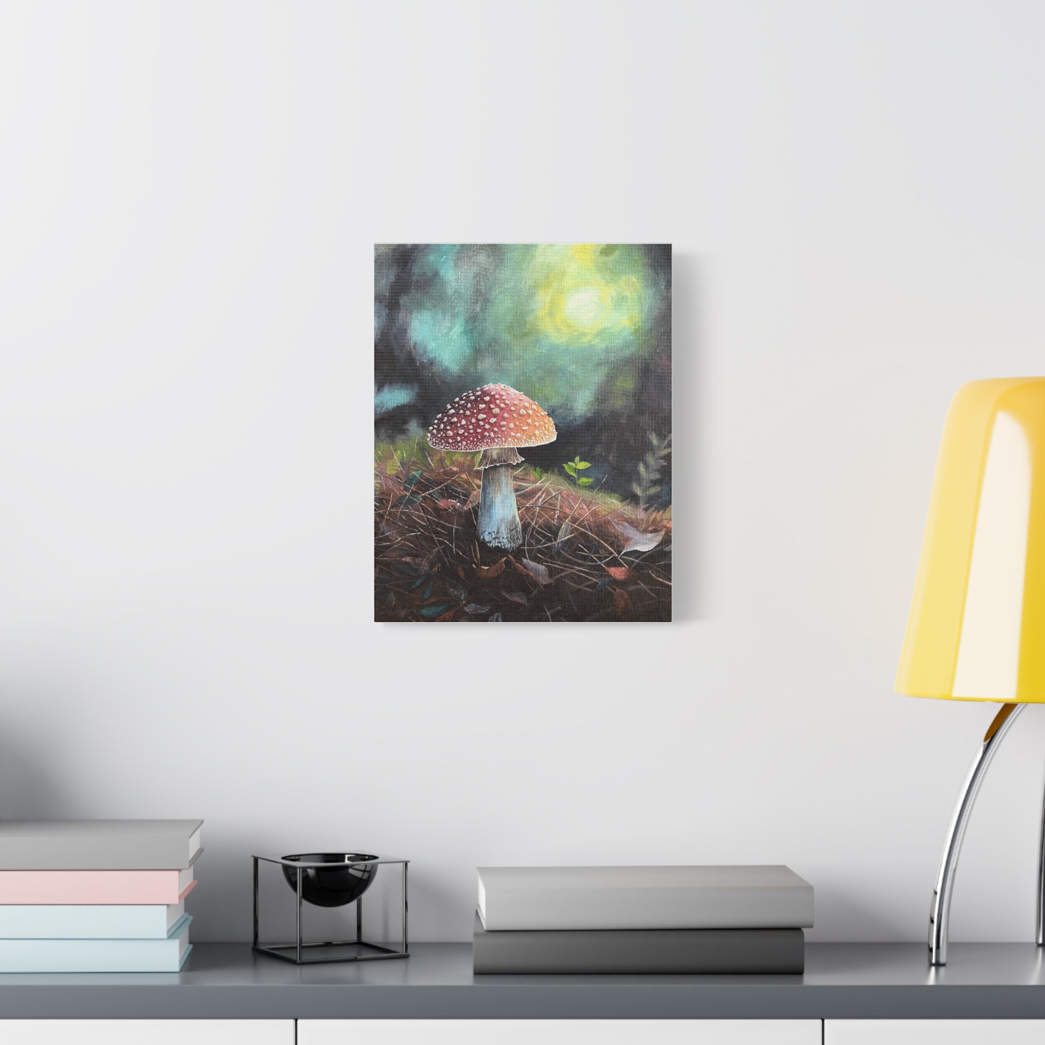 Canvas print of a mushroom painting on a wall above a desk with books and a lamp.