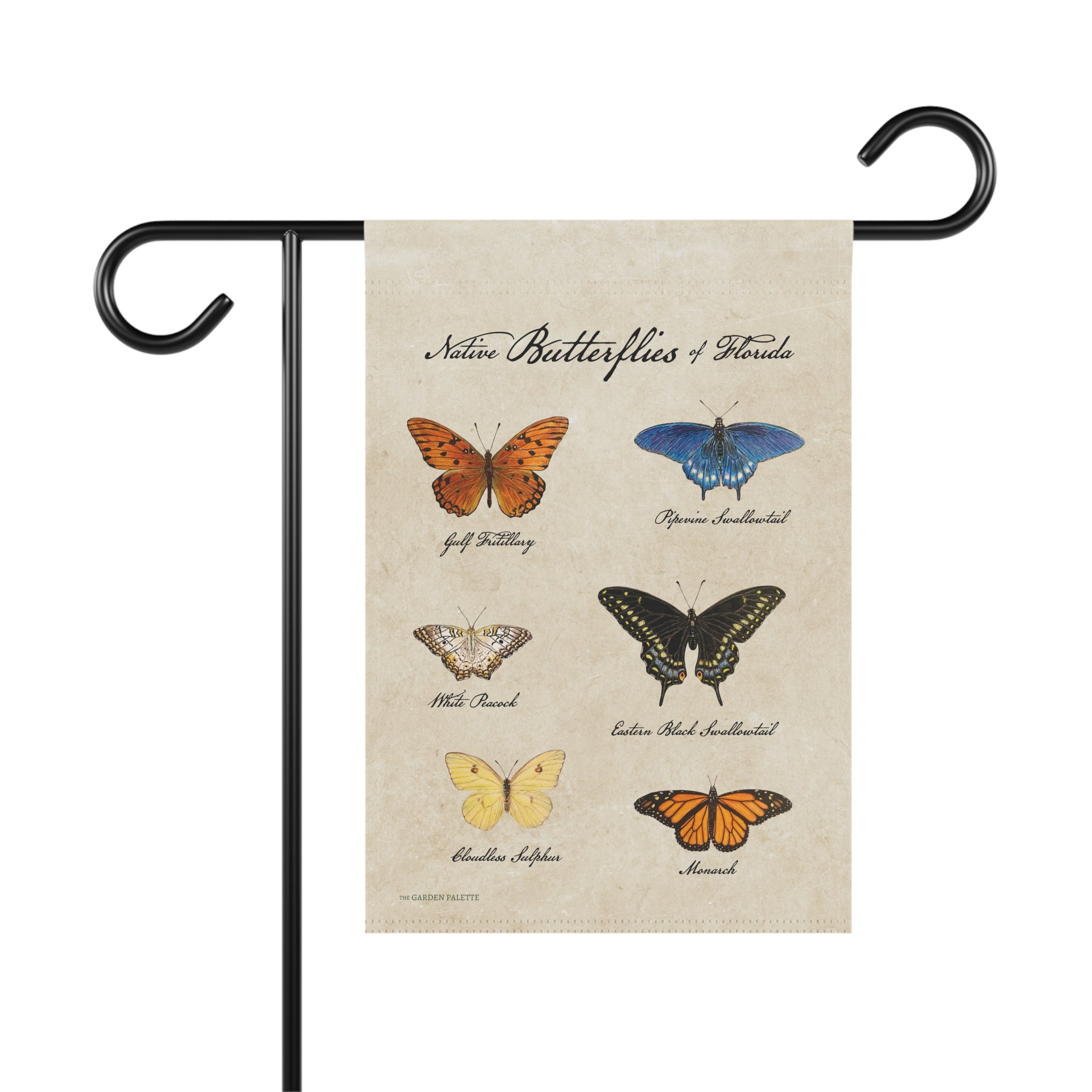 Decorative garden flag with illustrations of butterflies on a beige background, held by a black metal pole.