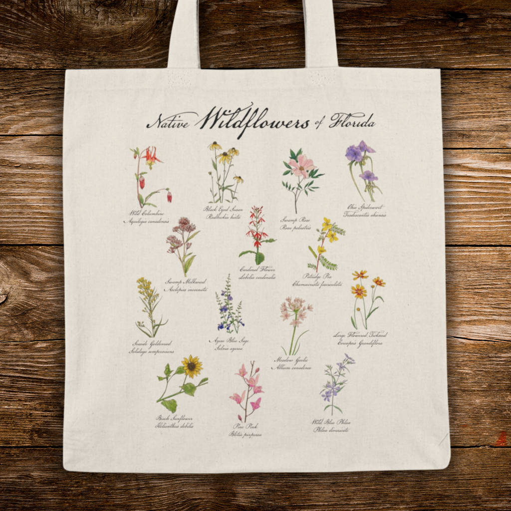 Tote bag with illustrations of Native Wildflowers of Florida on a wooden surface