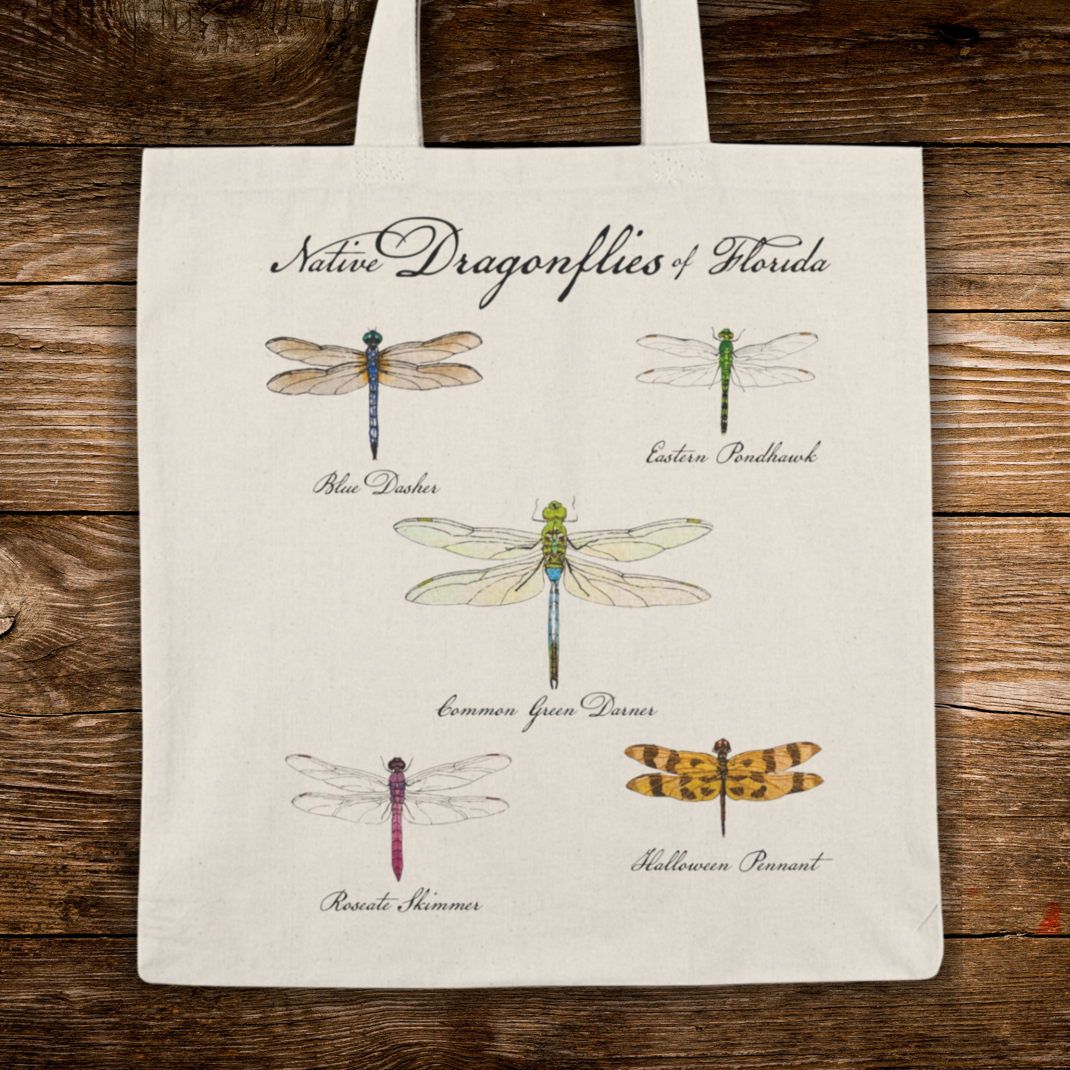 Tote bag with illustrations of native dragonflies of Florida on a wooden surface