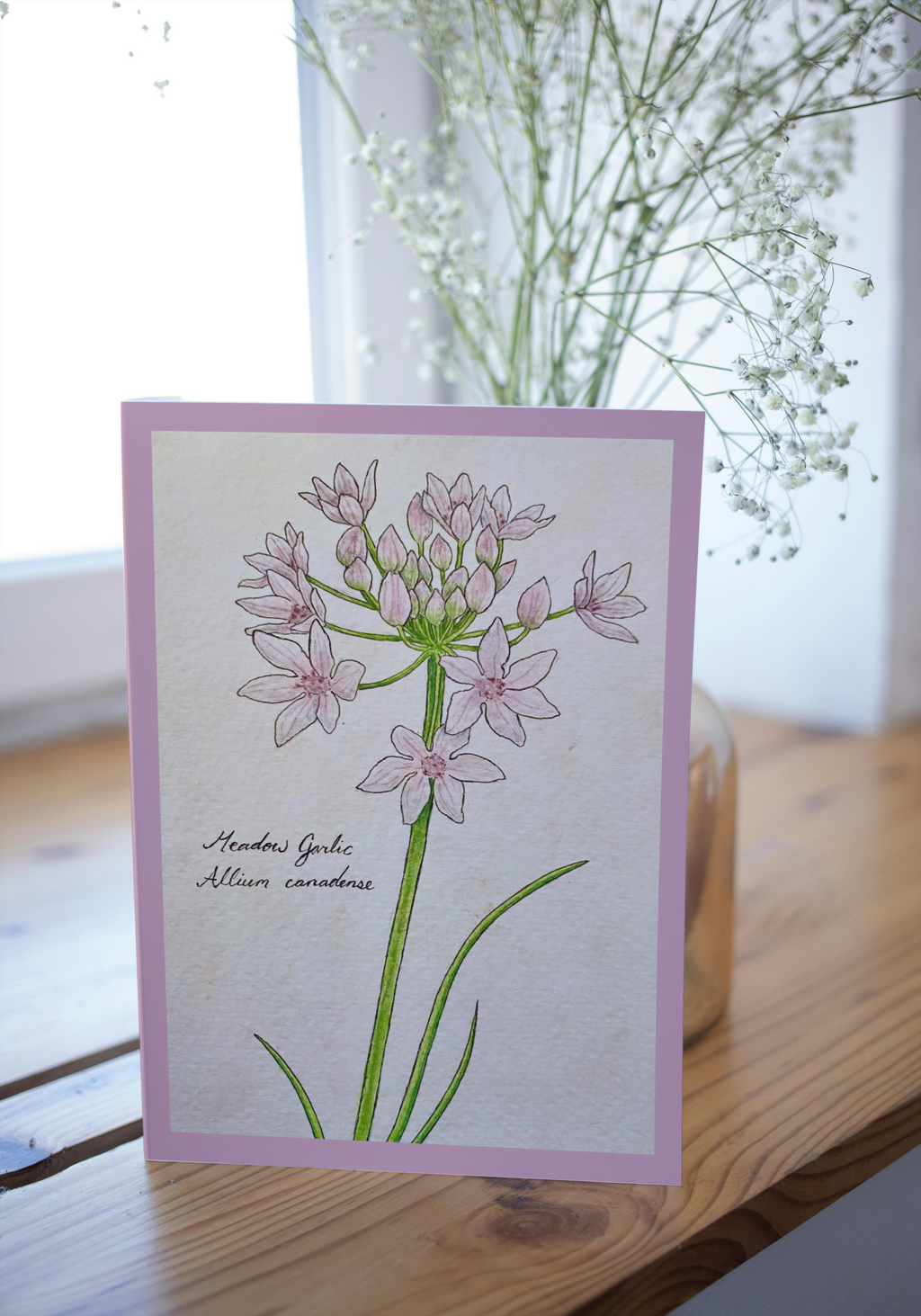 Greeting card on wood surface with a blurred background