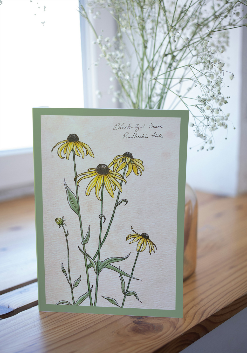 Greeting card on wood surface with blurred background