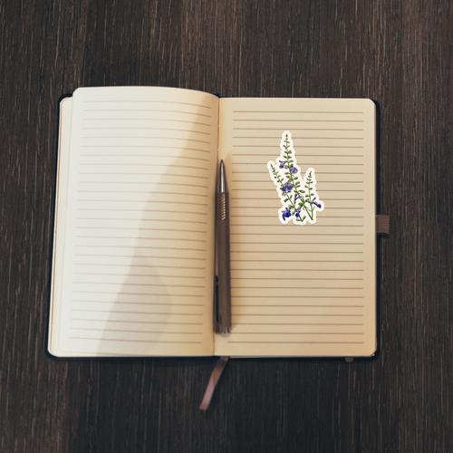 Floral sticker on an open notebook