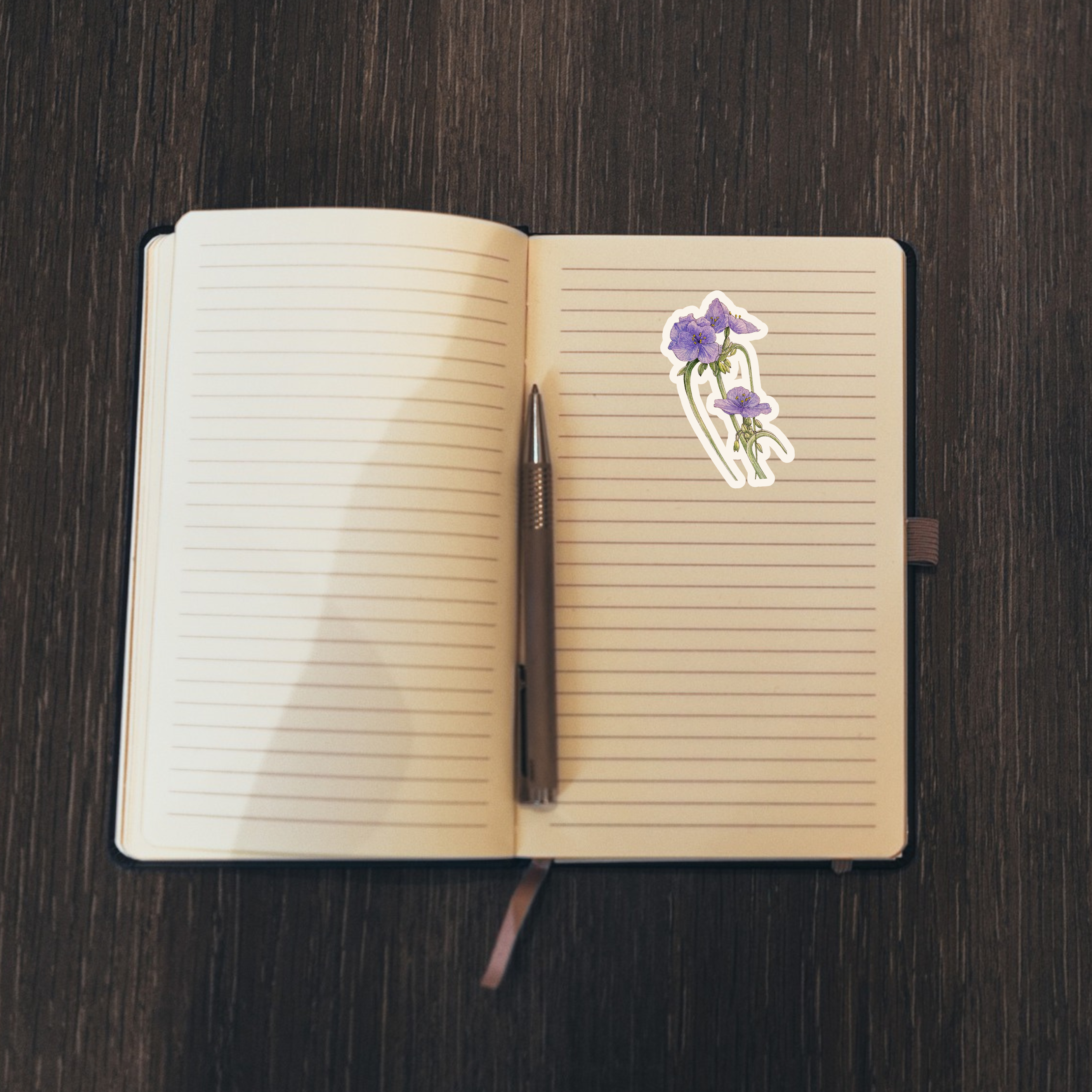 Floral sticker on an open notebook