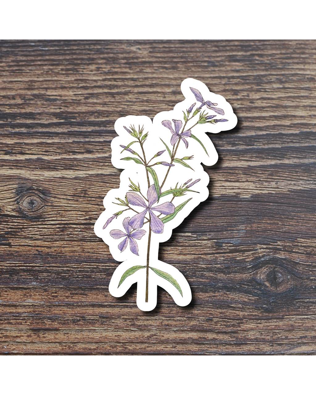 Floral sticker with purple flowers on a wooden surface