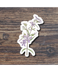 Floral sticker with purple flowers on a wooden surface