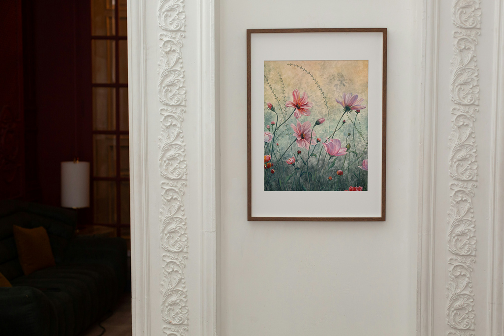 Framed print of pink flowers on a white wall