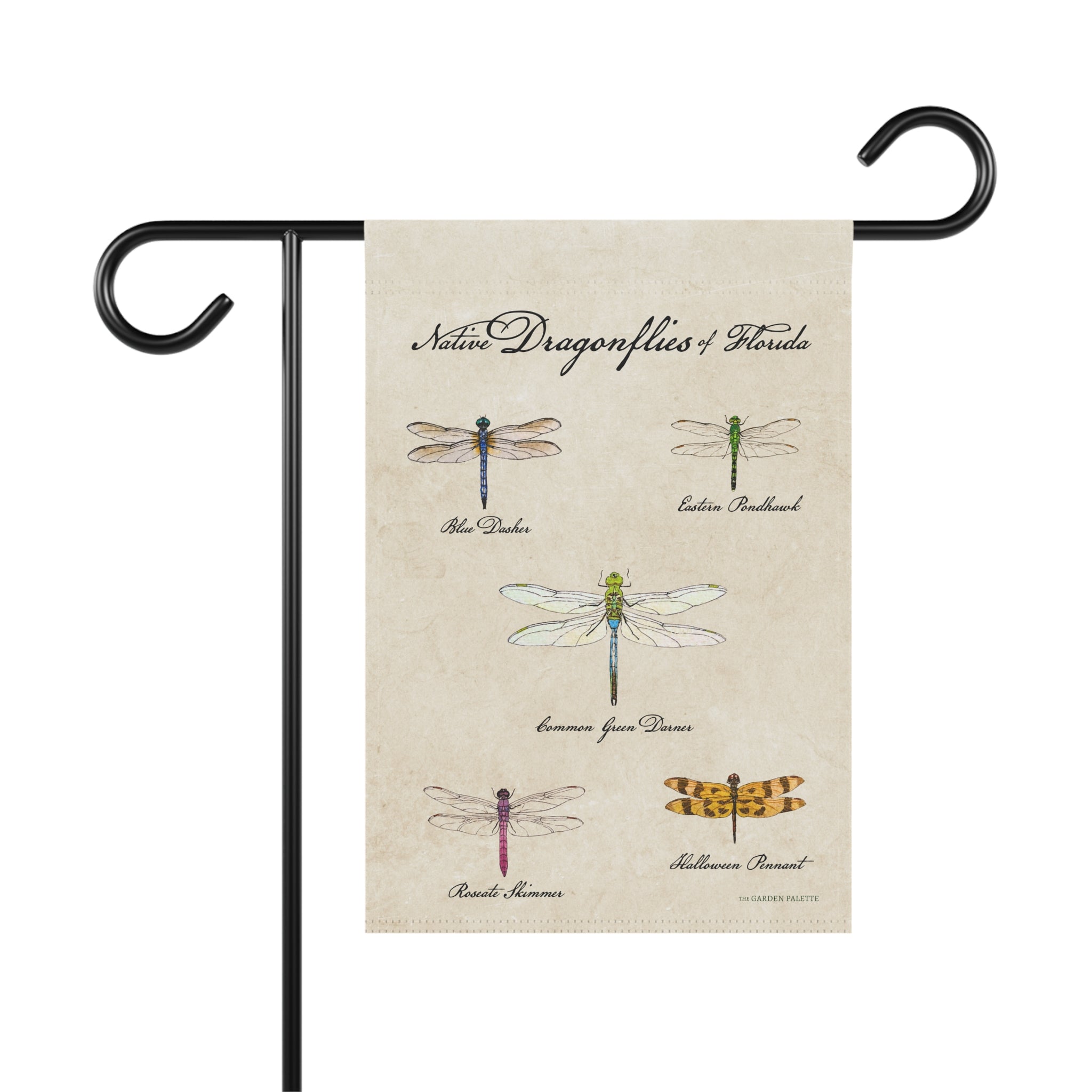 Decorative garden flag with illustrations of dragonflies on a beige background, attached to a black flagpole.