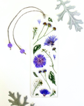A bookmark with purple flowers and green leaves on a white background