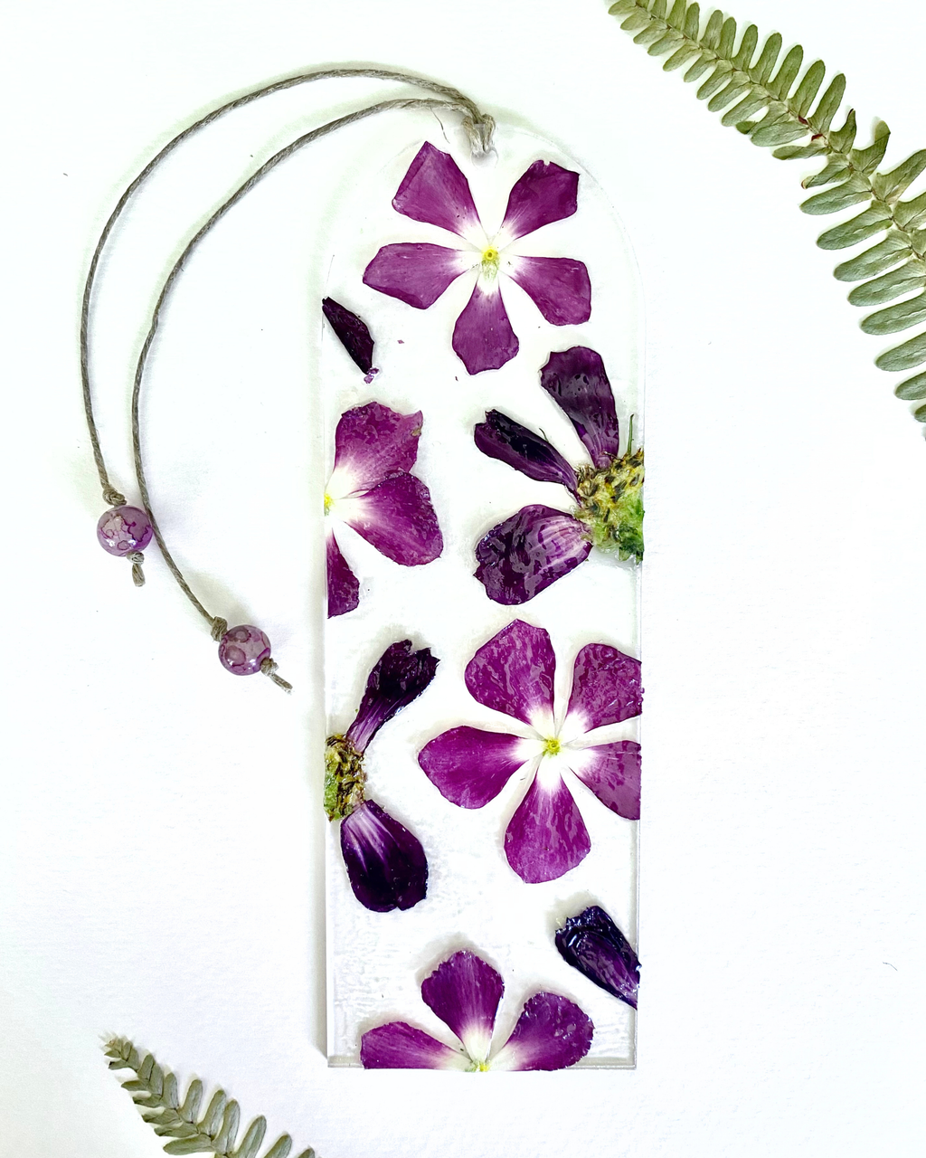 A bookmark with purple flowers on a white background