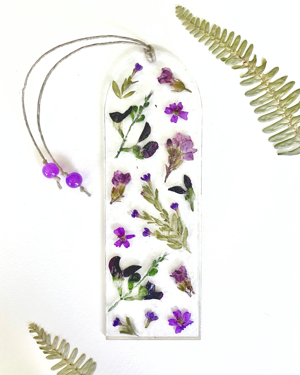 A bookmark with purple flowers on a white background