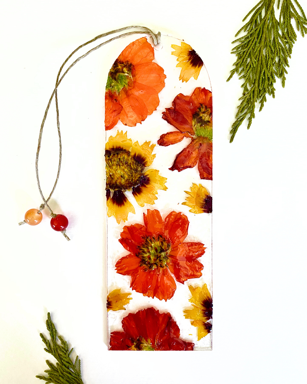 A bookmark with orange flowers on a white background