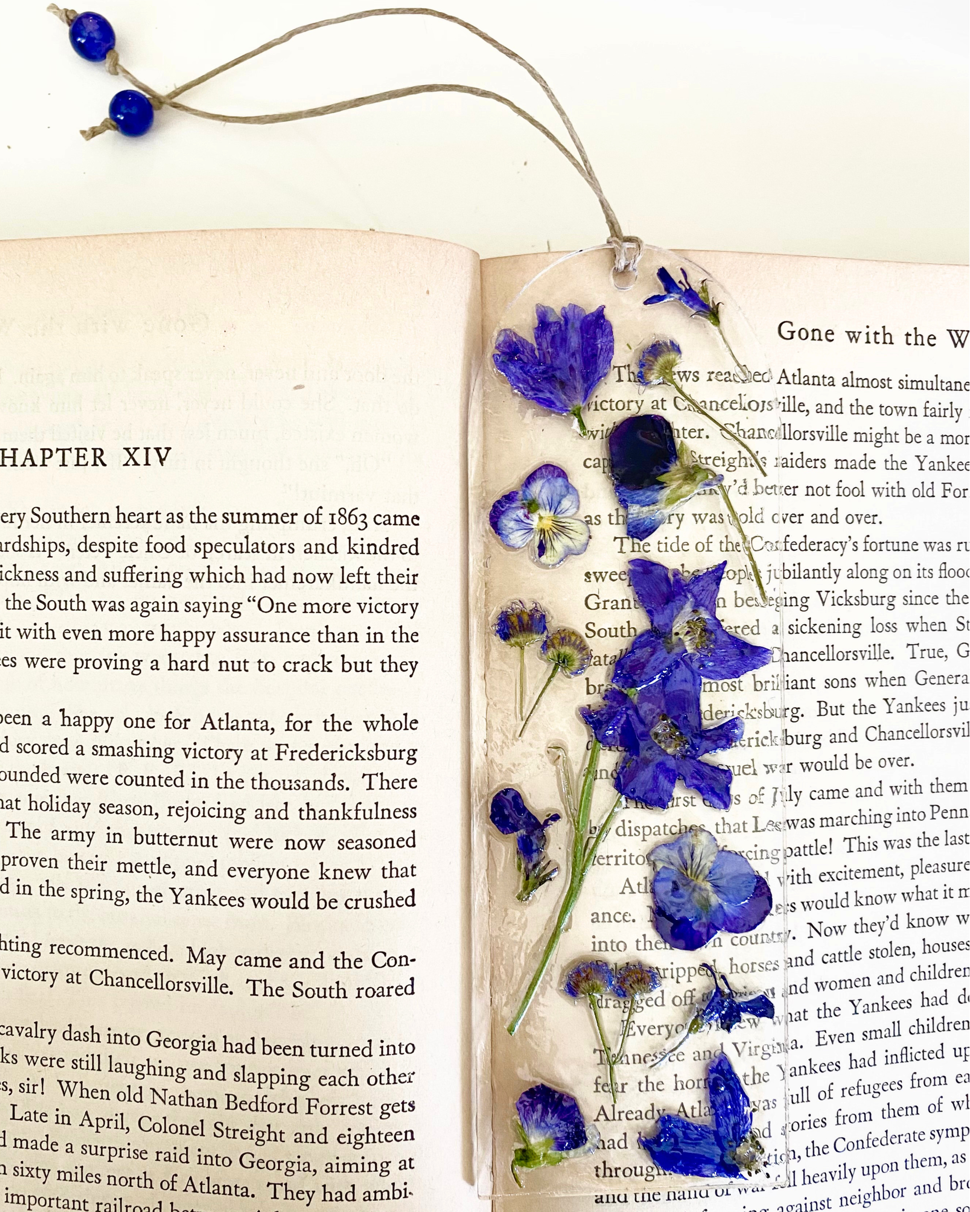 A bookmark with blue flowers on an open book